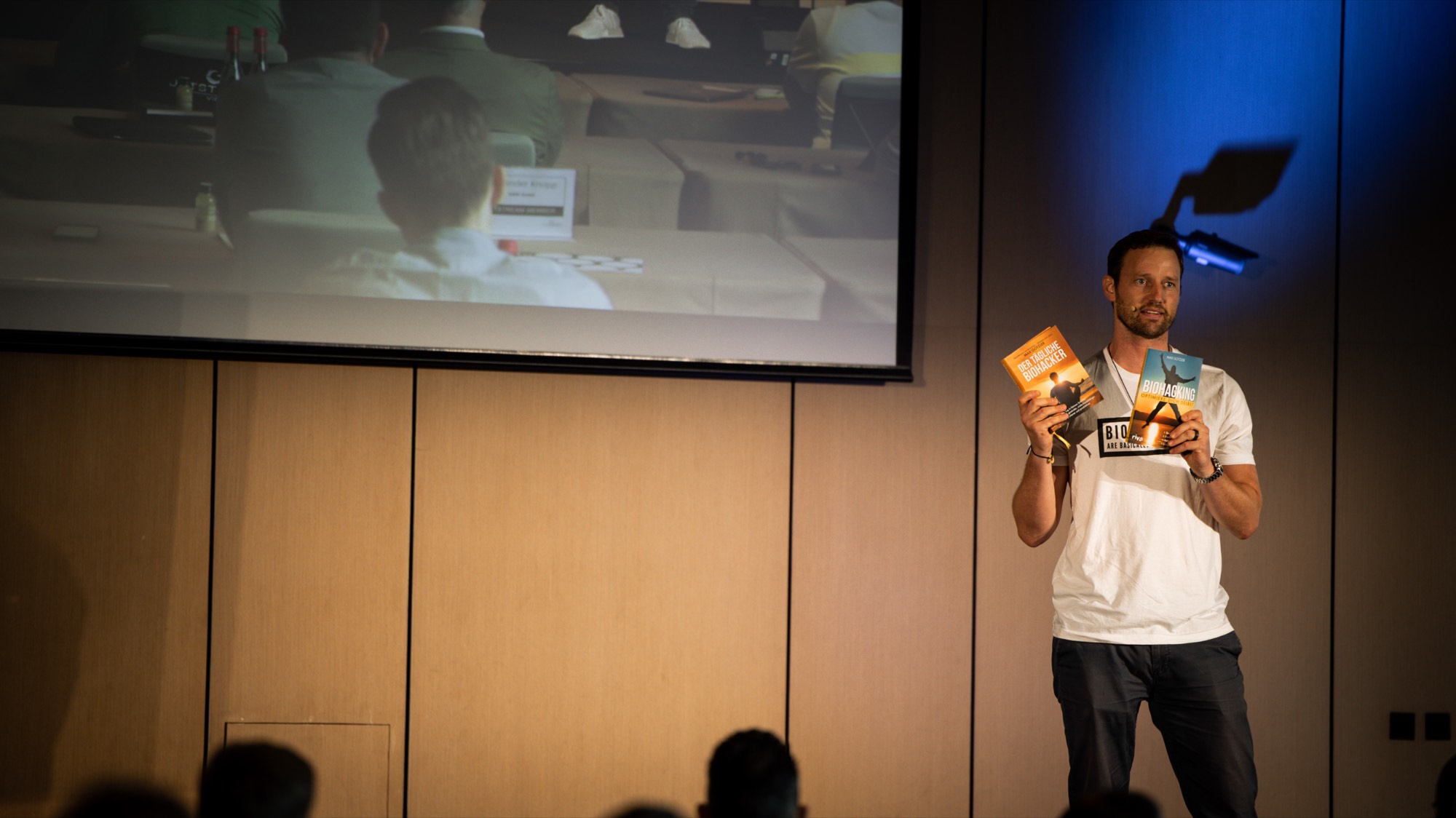 Max Gotzler on stage with his books